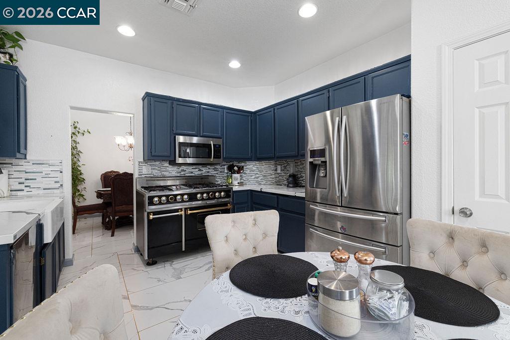 645 Anderson Way Rio Vista, CA 94571 - Photo 6 of 47 a kitchen with a refrigerator a stove a sink and a microwave