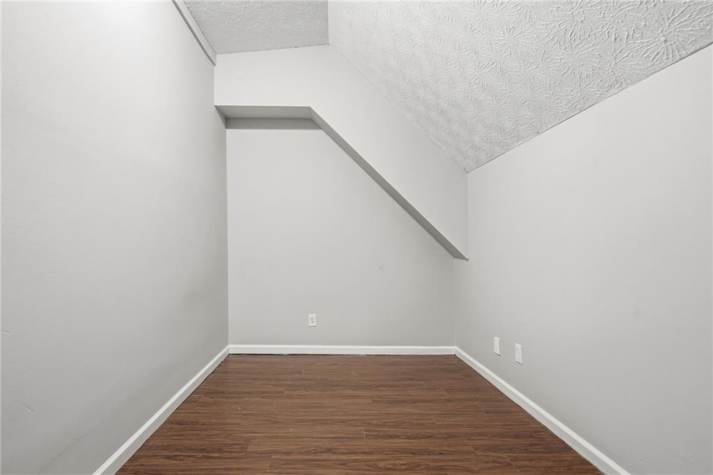 212 Chandler Street, Unit 4 Calhoun, GA 30701 - Photo 14 of 17 a view of an empty room with wooden floor