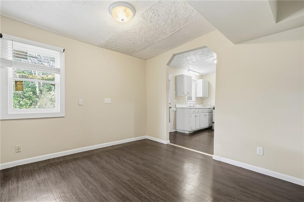 212 Chandler Street, Unit 4 Calhoun, GA 30701 - Photo 15 of 17 an empty room with wooden floor and windows