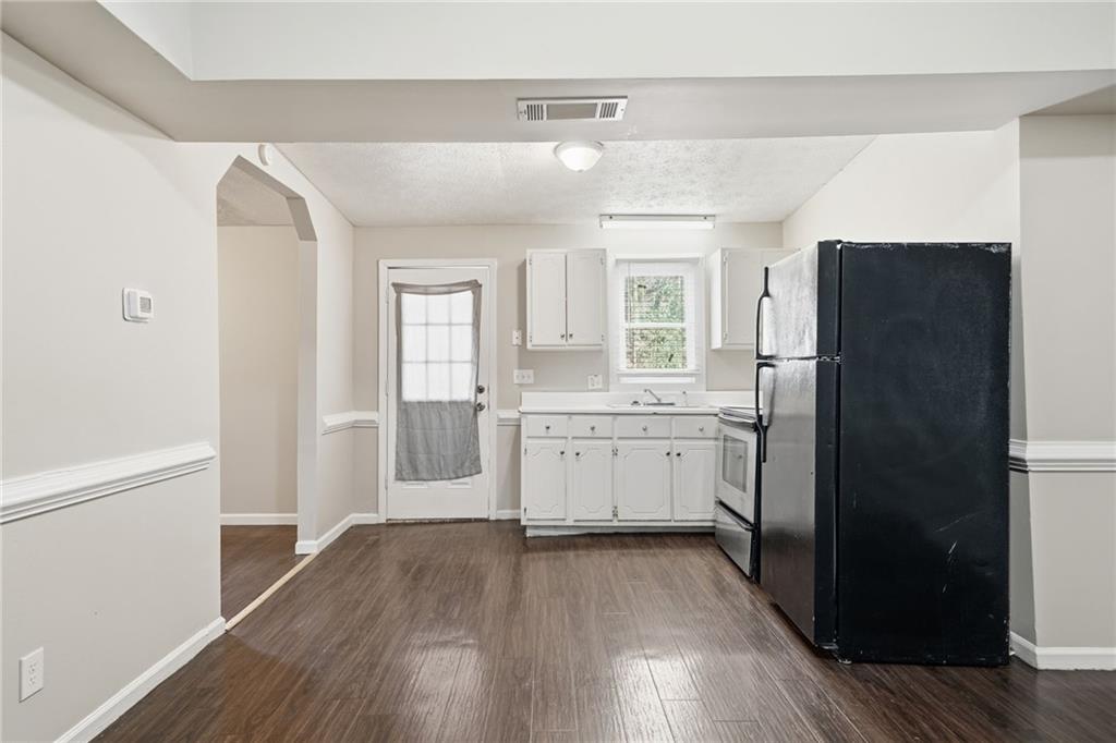 212 Chandler Street, Unit 4 Calhoun, GA 30701 - Photo 2 of 17 a kitchen with a refrigerator sink and cabinets
