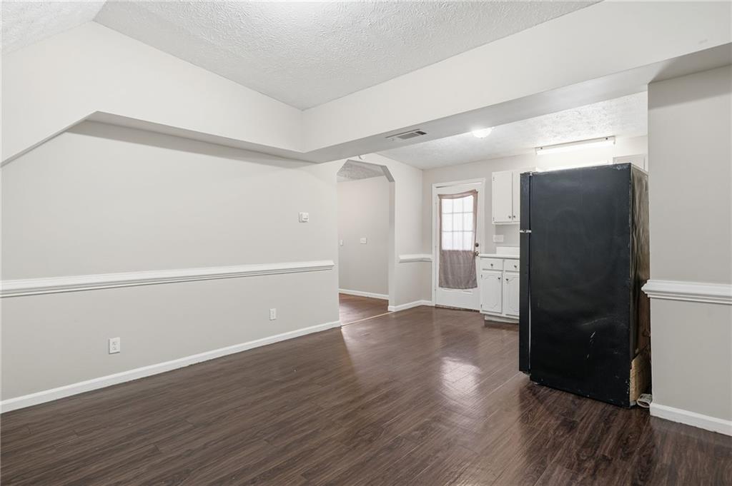 212 Chandler Street, Unit 4 Calhoun, GA 30701 - Photo 3 of 17 a view of an empty room with wooden floor and a window