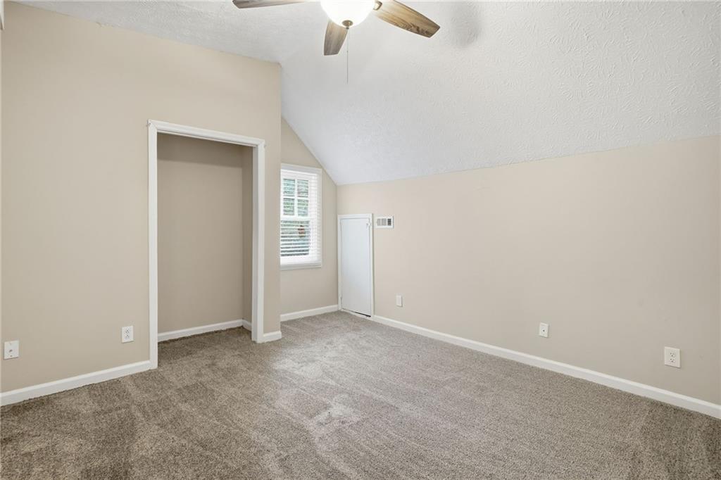 212 Chandler Street, Unit 4 Calhoun, GA 30701 - Photo 5 of 17 an empty room with a empty space and a ceiling fan