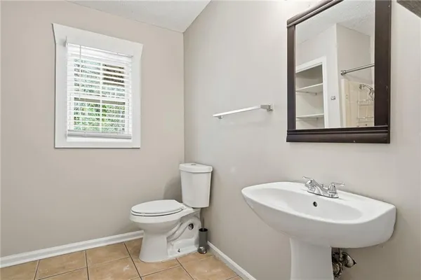 a bathroom with a sink toilet and a mirror