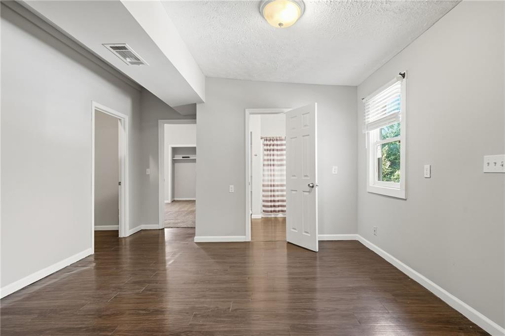 212 Chandler Street, Unit 4 Calhoun, GA 30701 - Photo 10 of 17 an empty room with wooden floor and windows