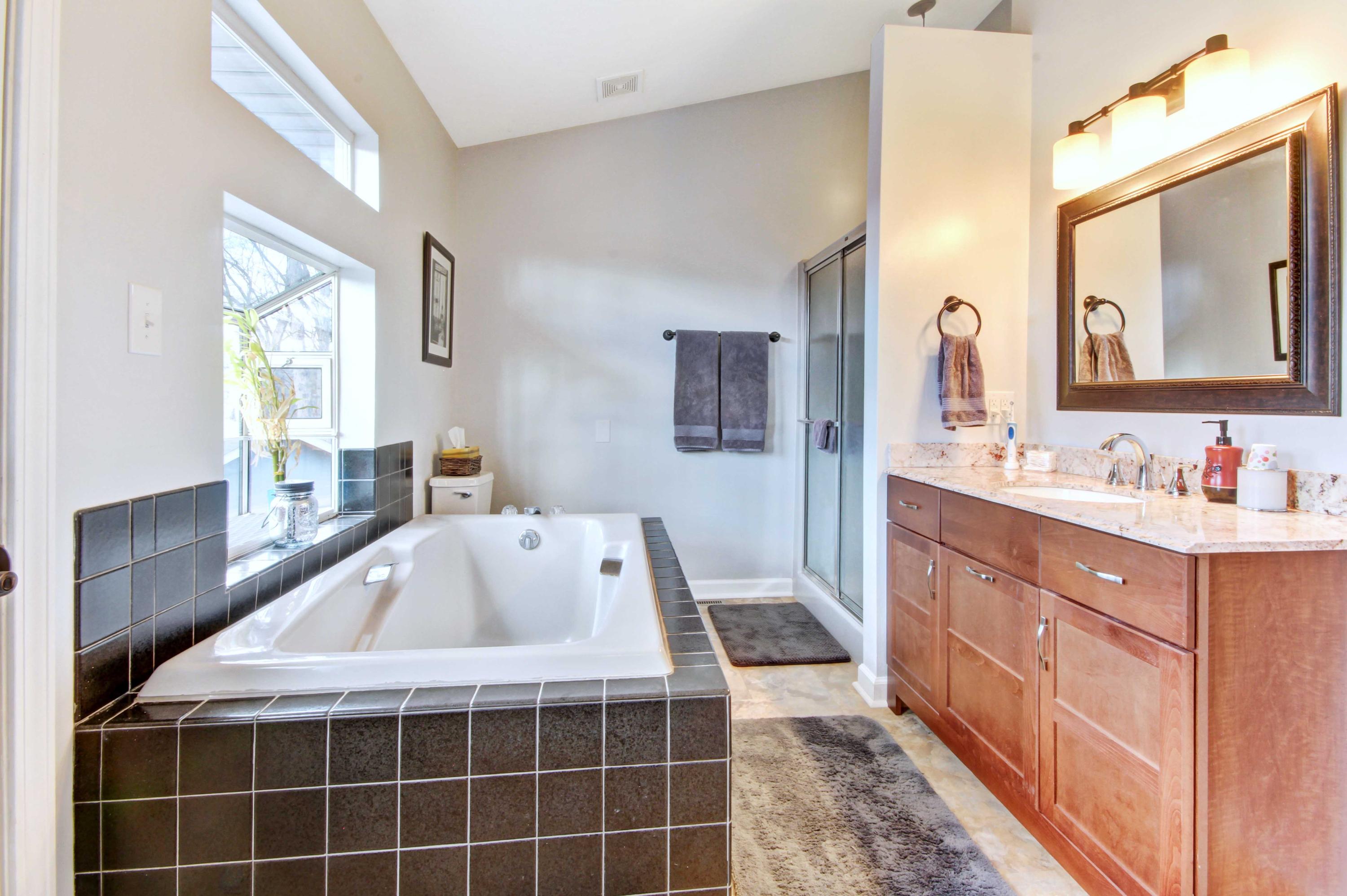 3355 Turner Branch Road Vinton, VA 24179 - Photo 16 of 58 a bathroom with a tub sink and mirror