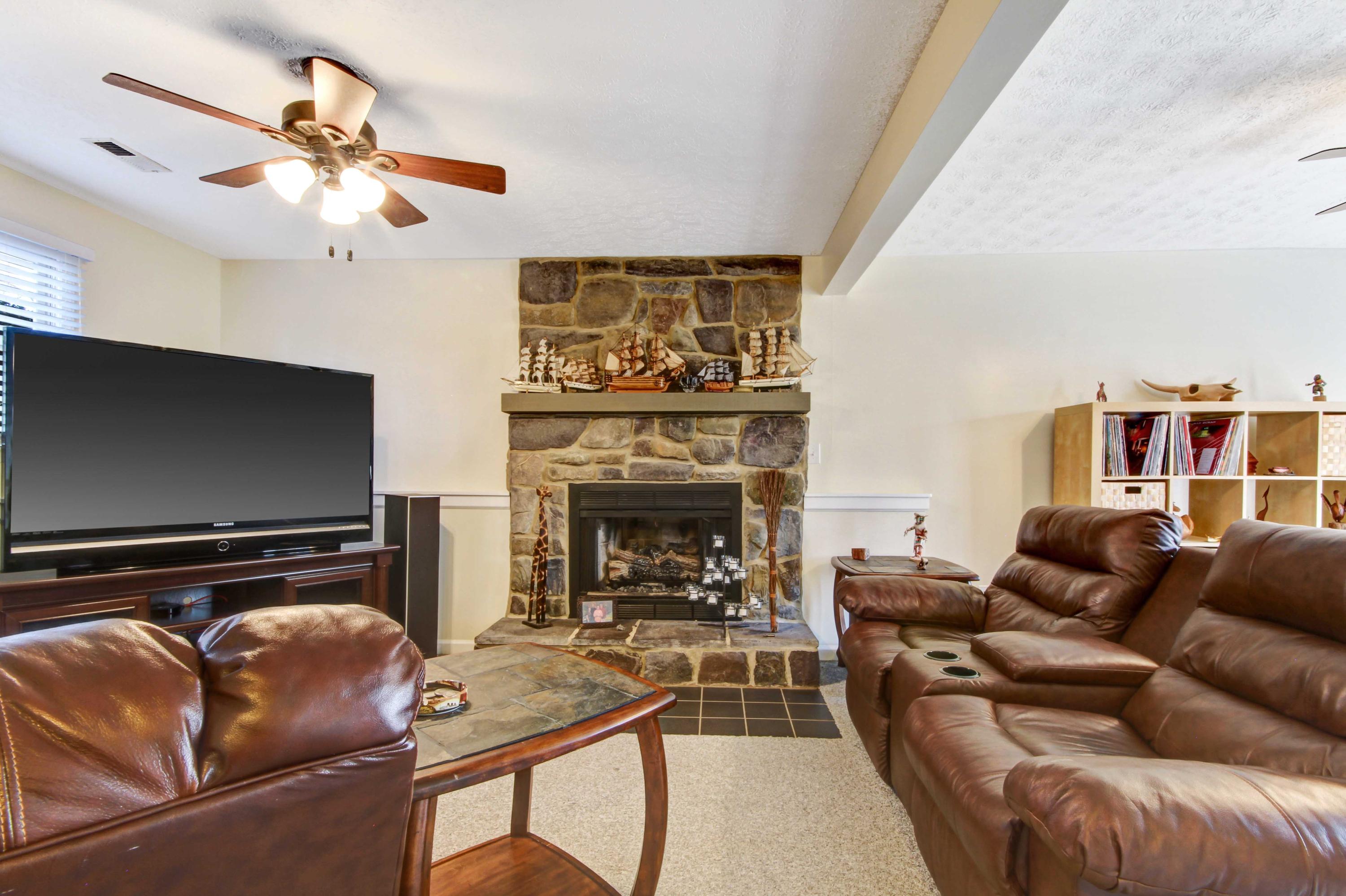 3355 Turner Branch Road Vinton, VA 24179 - Photo 21 of 58 a living room with furniture a fireplace and a flat screen tv