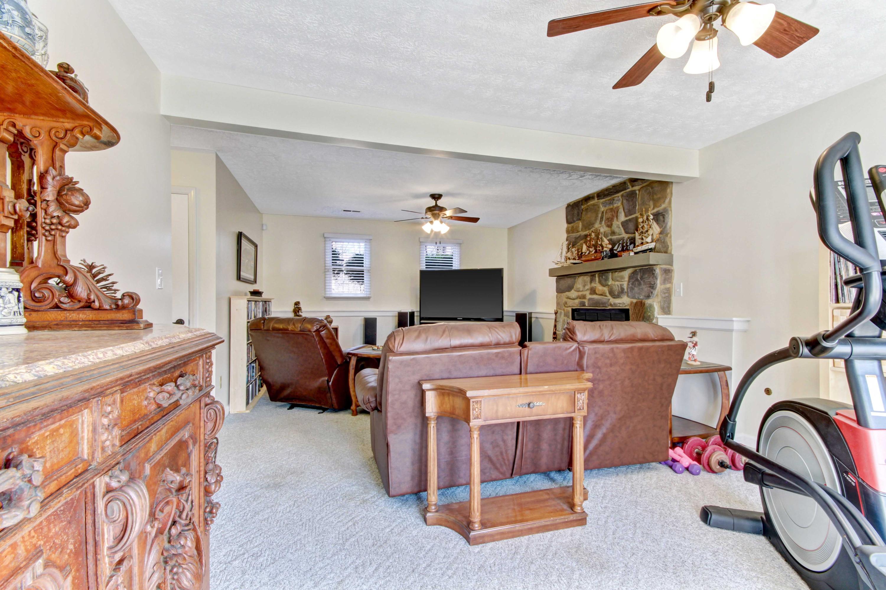 3355 Turner Branch Road Vinton, VA 24179 - Photo 24 of 58 a living room with furniture a flat screen tv and a chandelier