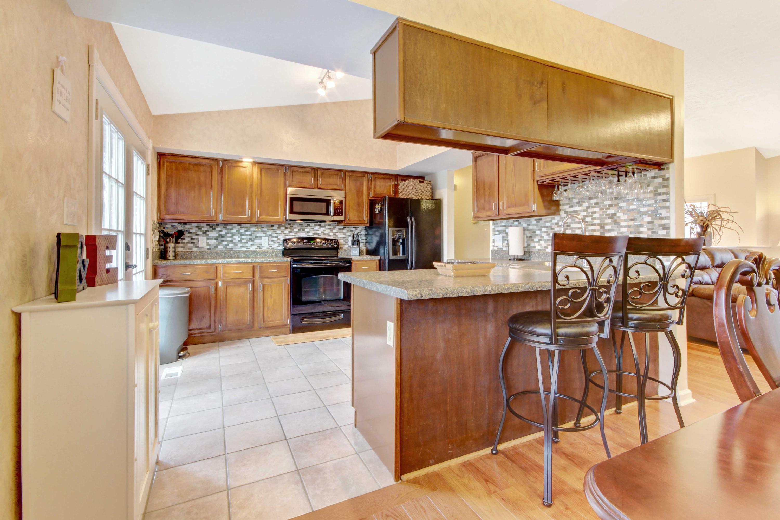 3355 Turner Branch Road Vinton, VA 24179 - Photo 6 of 58 a kitchen with stainless steel appliances kitchen island granite countertop a table chairs and a refrigerator