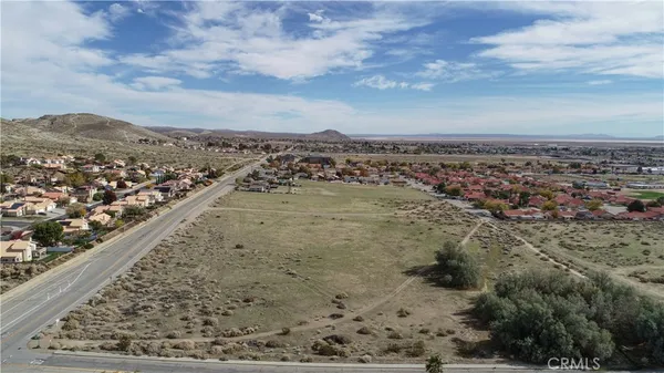 an aerial view of a residential houses with outdoor space