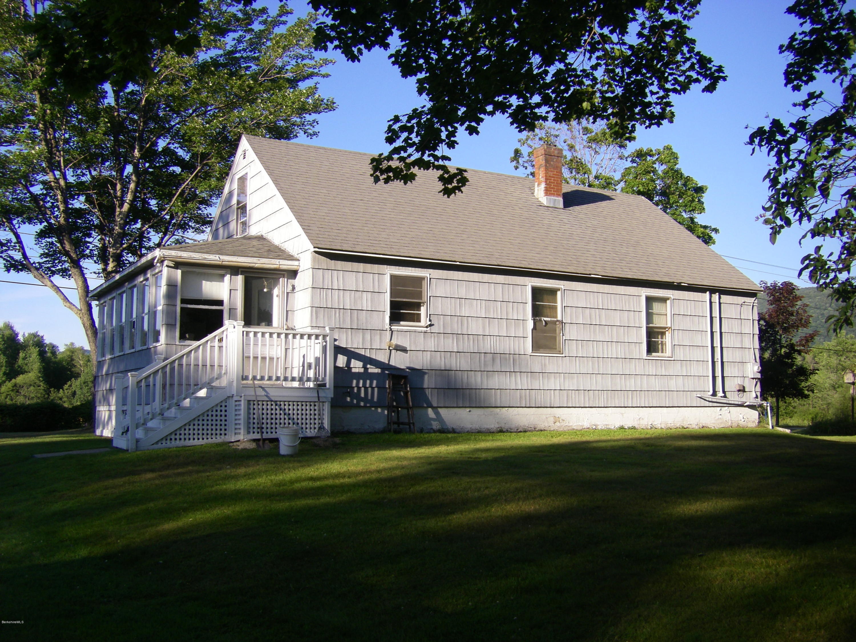 401 Cross Road Clarksburg, MA 01247 - Photo 2 of 26 a front view of a house with a garden