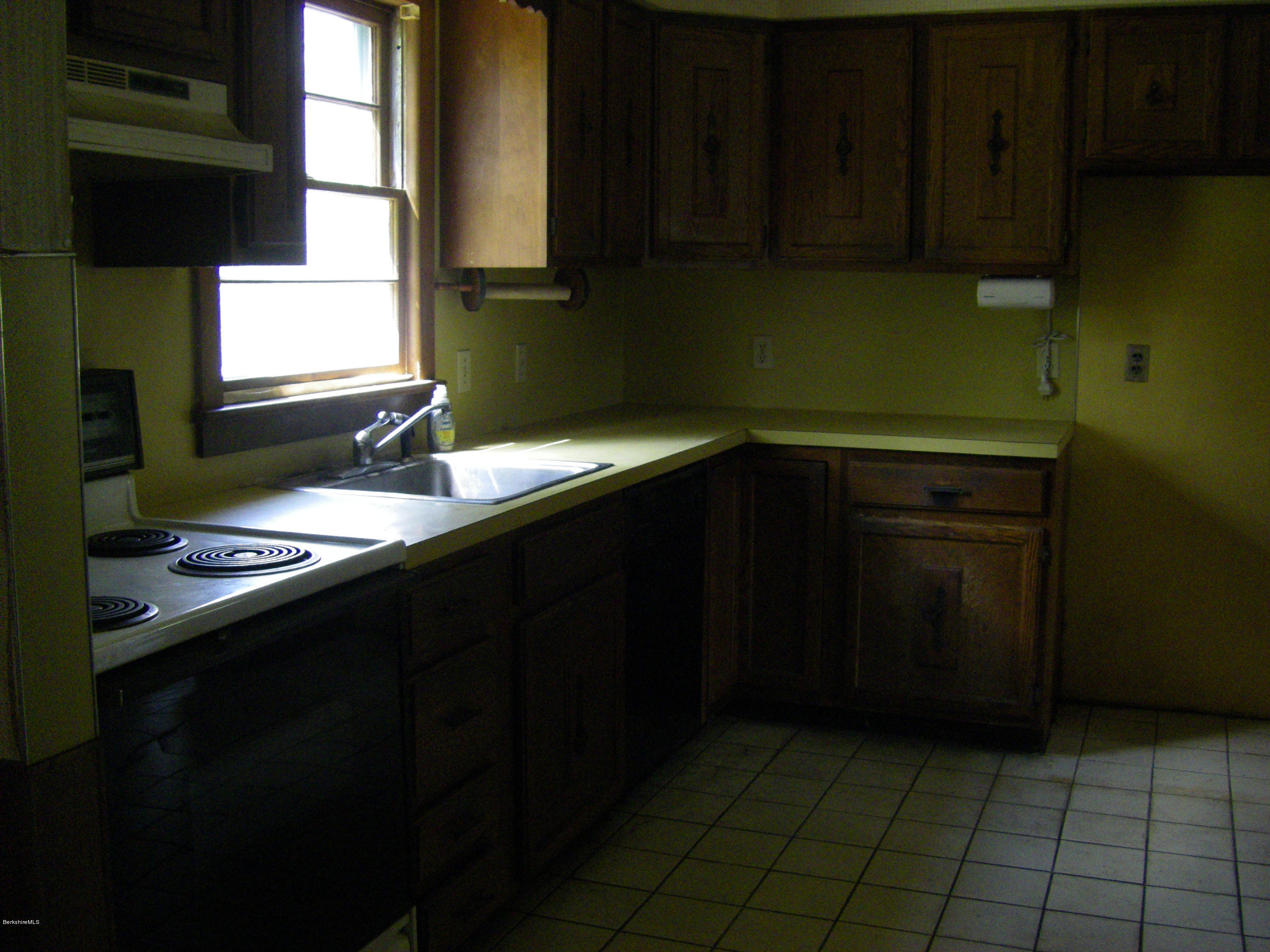 401 Cross Road Clarksburg, MA 01247 - Photo 13 of 26 a kitchen with a sink window and cabinets