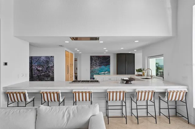 a kitchen with granite countertop a sink stove and cabinets
