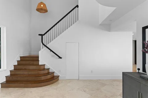 a kitchen with a sink and a wooden floor