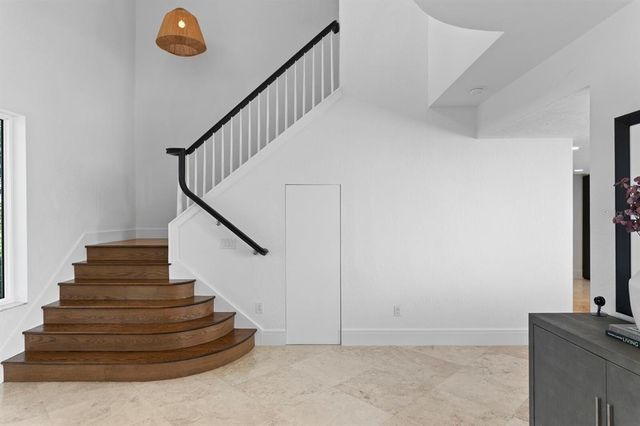 a kitchen with a sink and a wooden floor