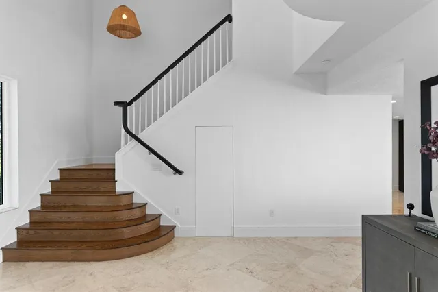 a kitchen with a sink and a wooden floor