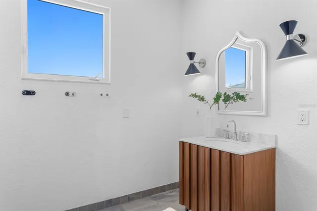 a spacious bedroom with a large bed and a large window