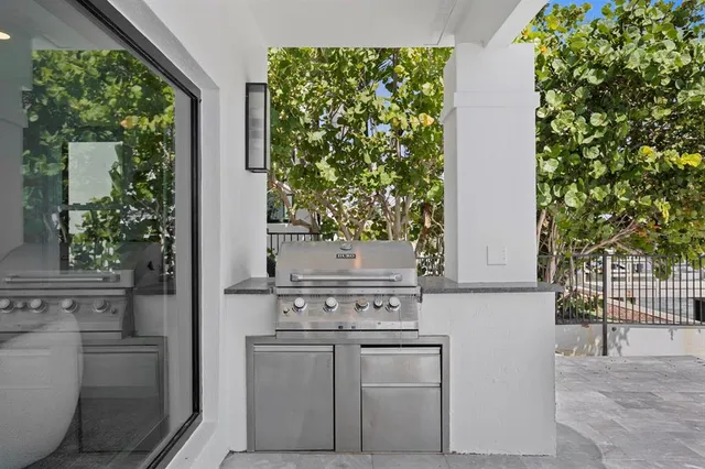 a roof deck with a table and chairs under an umbrella