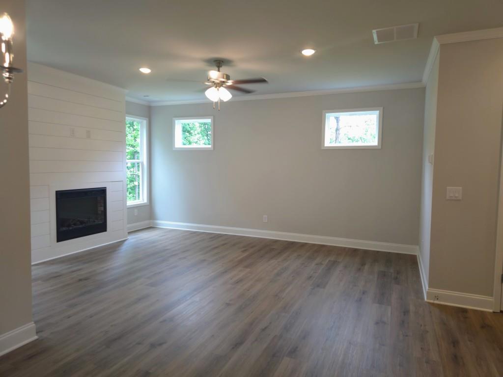 4240 Cavalier Way Duluth, GA 30097 - Photo 10 of 46 an empty room with wooden floor and chandelier fan