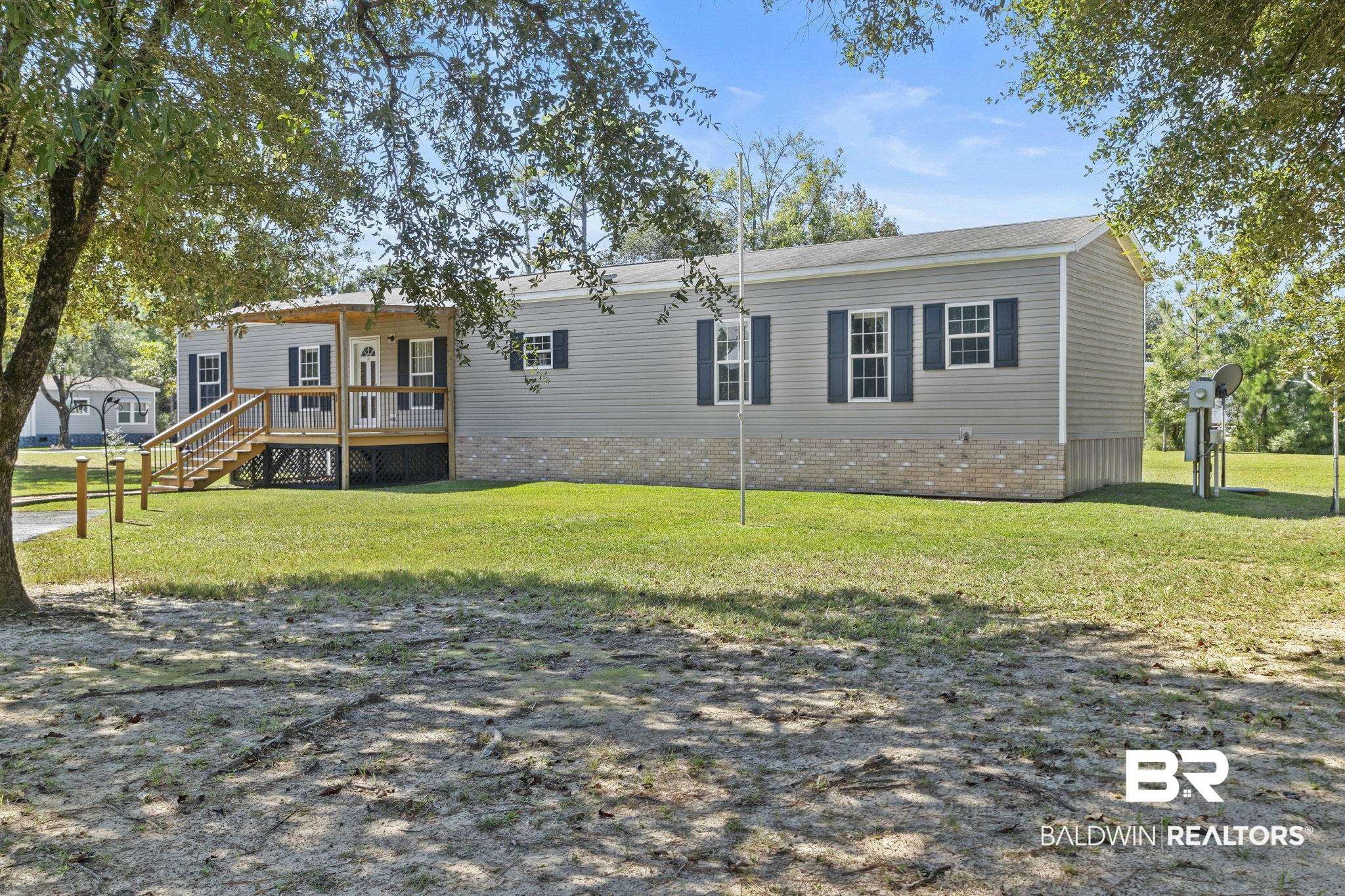 6870 Cecilia Court Theodore, AL 36582 - Photo 7 of 83 Exterior space featuring a yard and a wooden deck