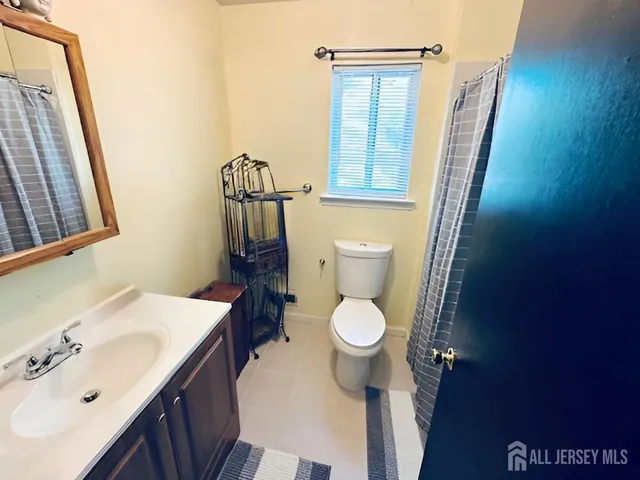 a white toilet sitting next to a bathroom sink