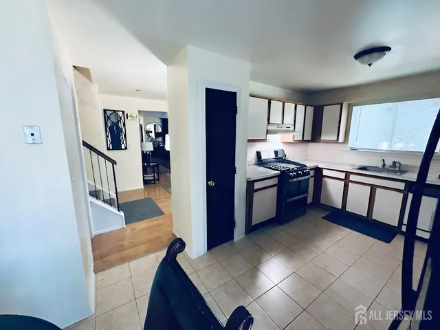 a kitchen with stainless steel appliances granite countertop a refrigerator and a stove