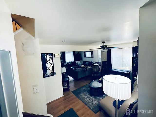 a living room with furniture and a mirror