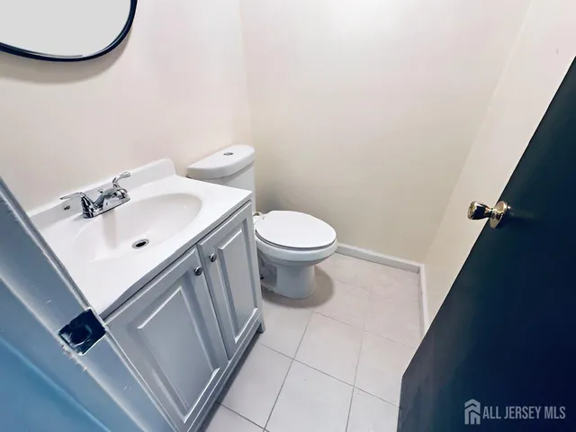 a bathroom with a sink a toilet and mirror