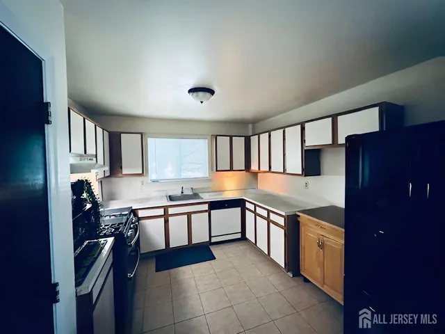 a kitchen with stainless steel appliances granite countertop a sink and stove