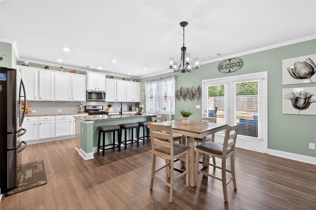 4479 Big Rock Rdg Trail Gainesville, GA 30504 - Photo 11 of 45 a view of a dining room and livingroom with furniture wooden floor a chandelier