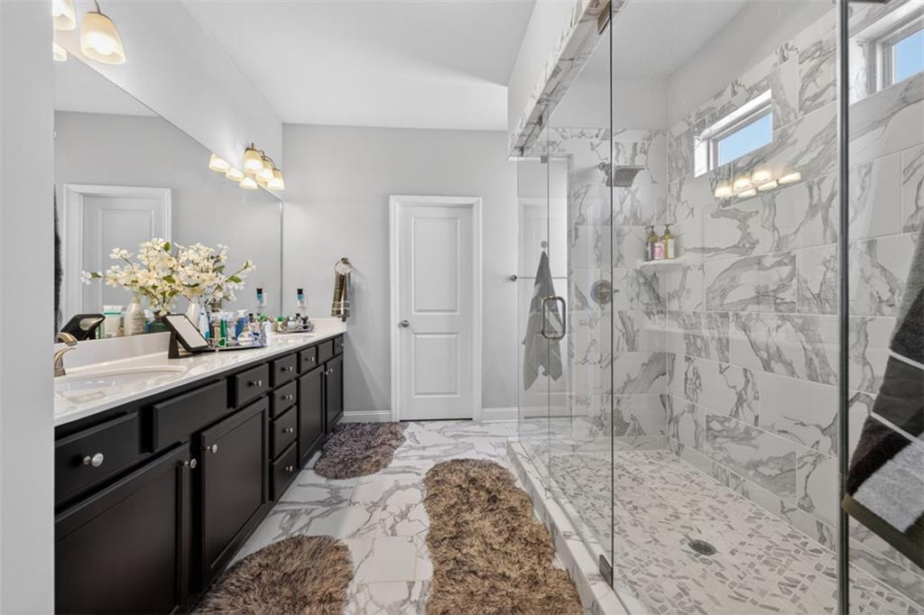 4479 Big Rock Rdg Trail Gainesville, GA 30504 - Photo 22 of 45 a spacious bathroom with a double vanity sink mirror and shower