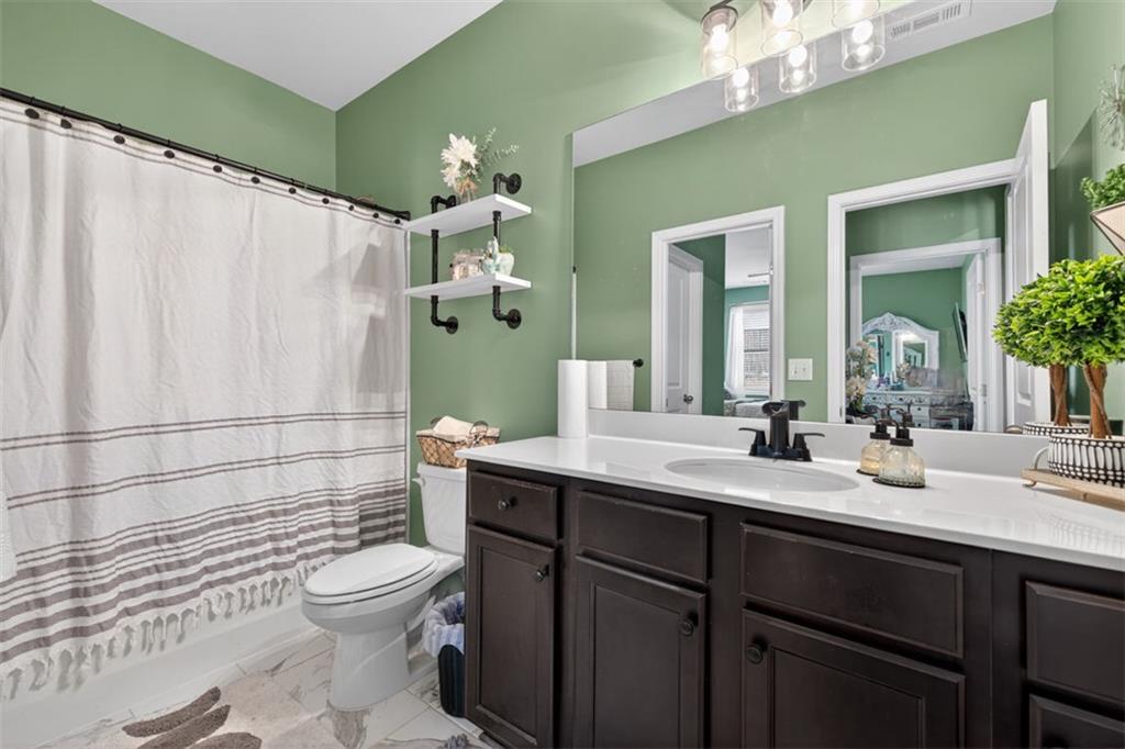4479 Big Rock Rdg Trail Gainesville, GA 30504 - Photo 26 of 45 a bathroom with a sink a toilet and shower