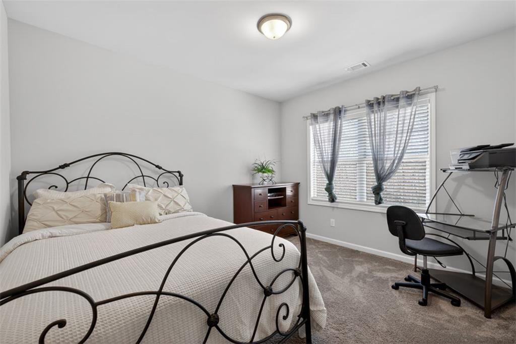 4479 Big Rock Rdg Trail Gainesville, GA 30504 - Photo 29 of 45 a bedroom with a bed a desk and chair with window