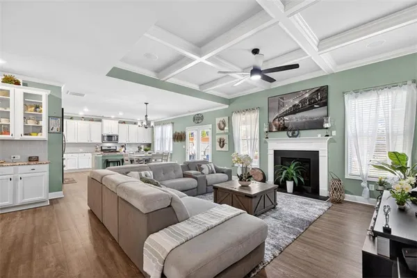 a living room with furniture fireplace and wooden floor