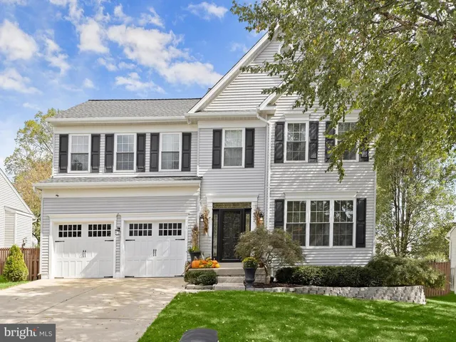 a front view of a house with a yard and porch