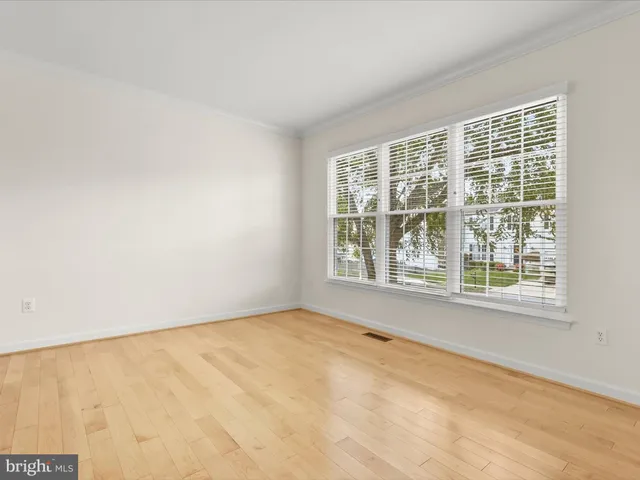 a dining room with furniture a chandelier and wooden floor