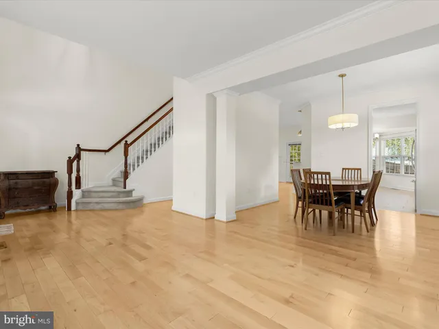a view of a dining room with furniture wooden floor and chandelier