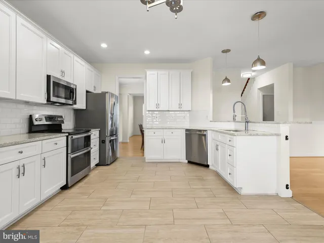a view of an empty room with a fireplace and a window