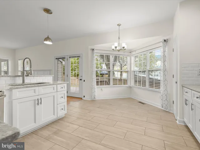 a work room with furniture a rug and a window