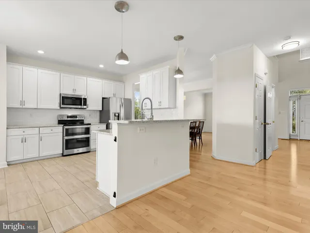 a bathroom with a granite countertop tub sink and mirror