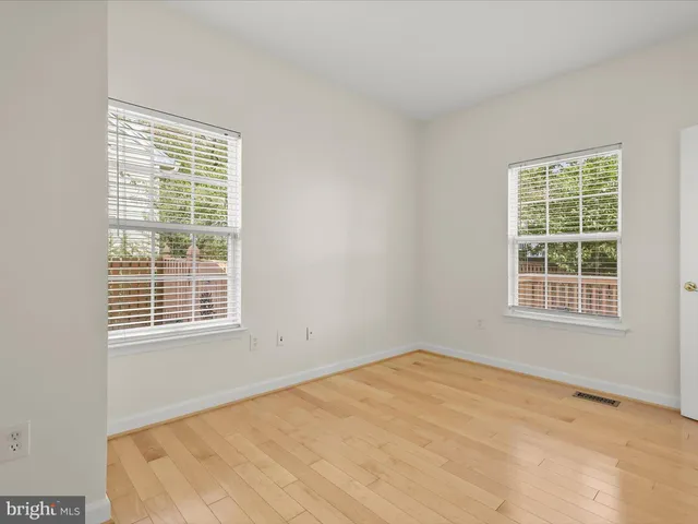 an empty room with a fireplace and cabinet