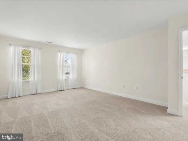 a balcony with wooden floor and yard in the back