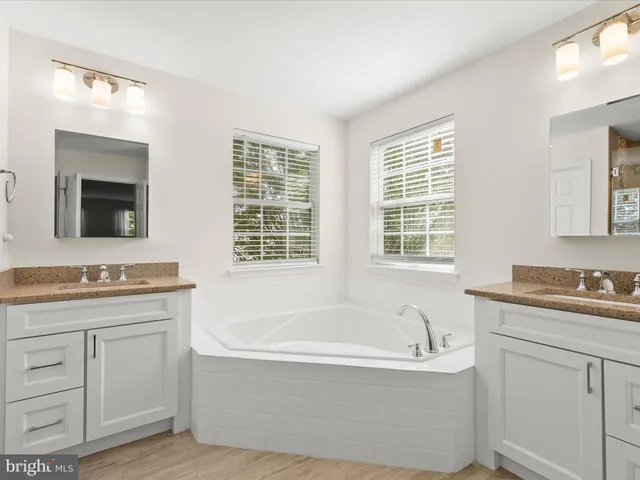 a view of a backyard with table and chairs with wooden fence
