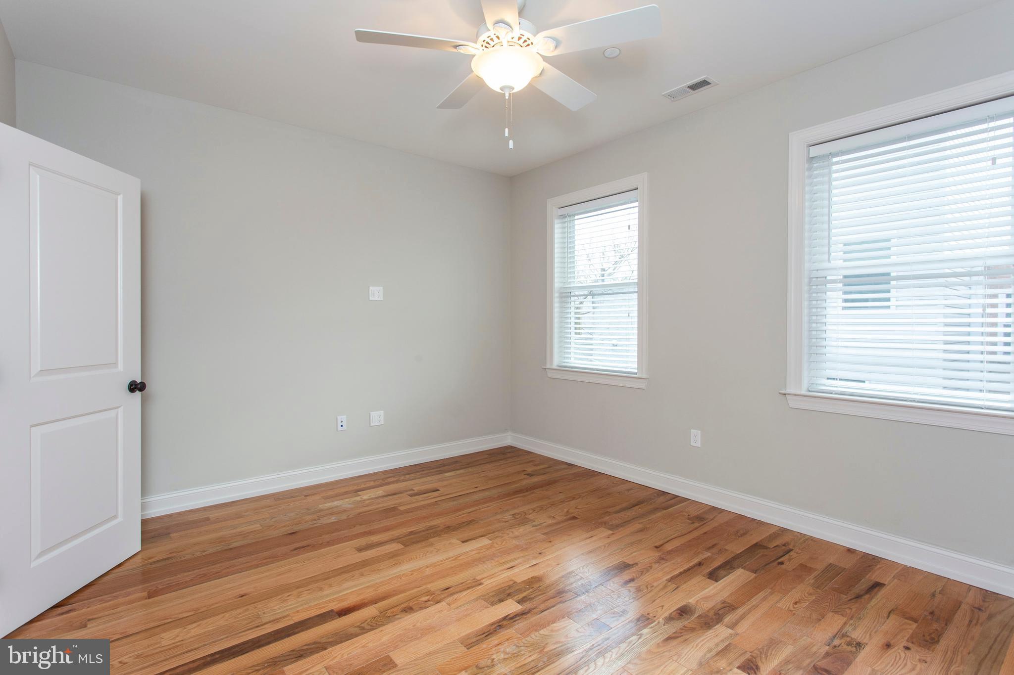 2052 Gerritt Street Philadelphia, PA 19146 - Photo 17 of 32 a view of an empty room with wooden floor and a window