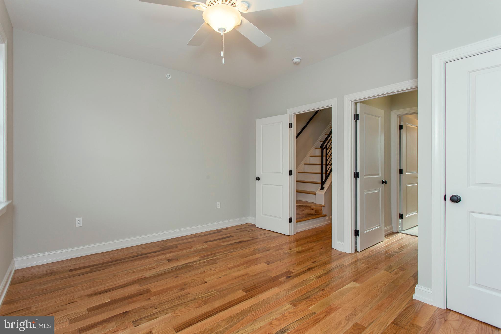 2052 Gerritt Street Philadelphia, PA 19146 - Photo 28 of 32 an empty room with wooden floor and ceiling fan