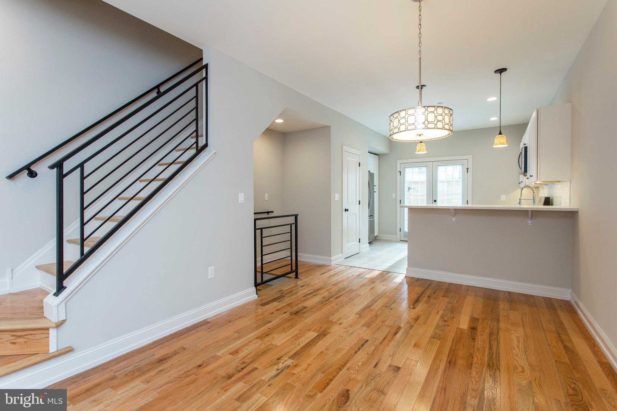 2052 Gerritt Street Philadelphia, PA 19146 - Photo 5 of 32 a view of a livingroom with wooden floor and stairs