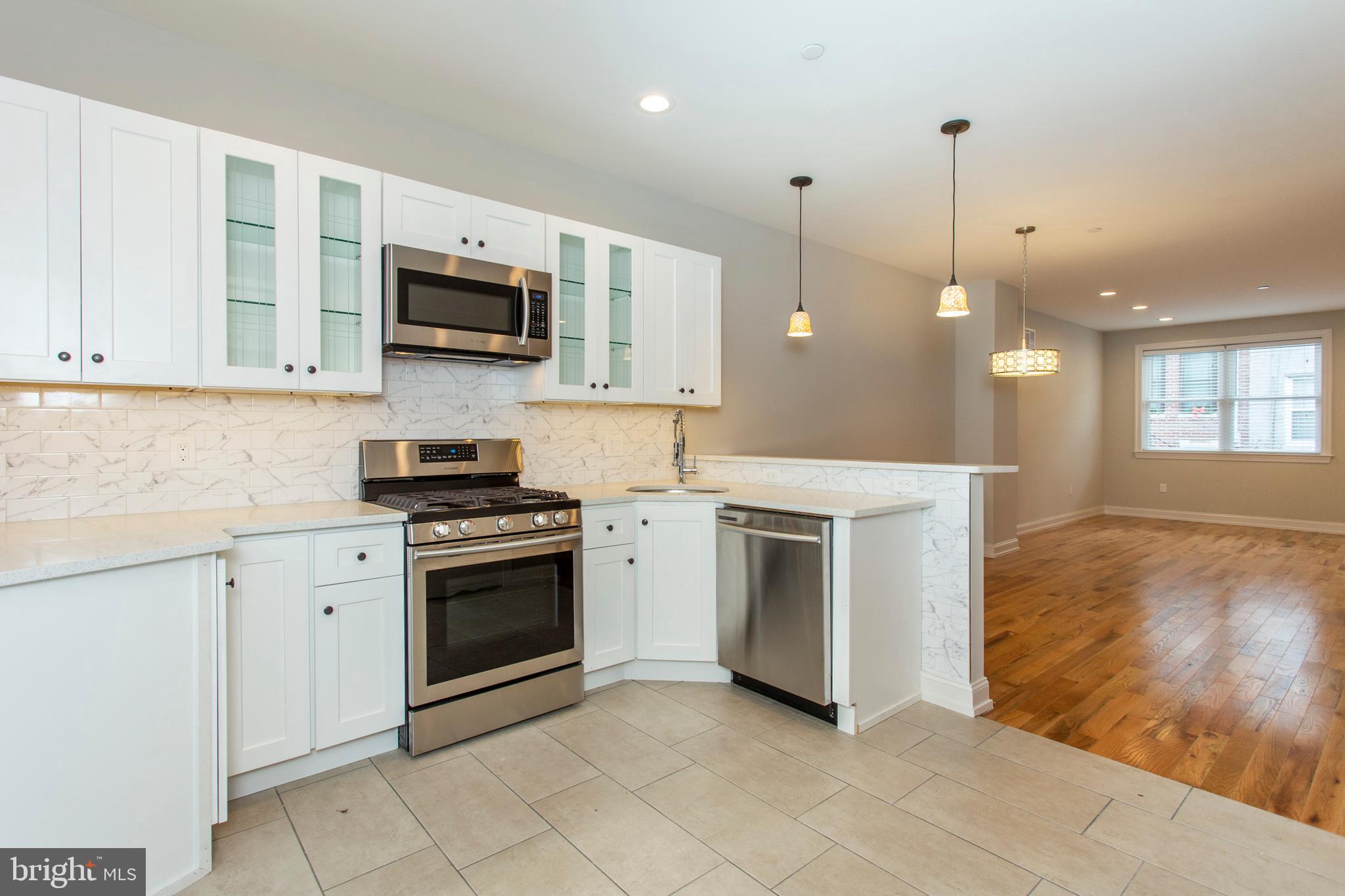 2052 Gerritt Street Philadelphia, PA 19146 - Photo 9 of 32 a kitchen with stainless steel appliances granite countertop a stove a sink and a microwave