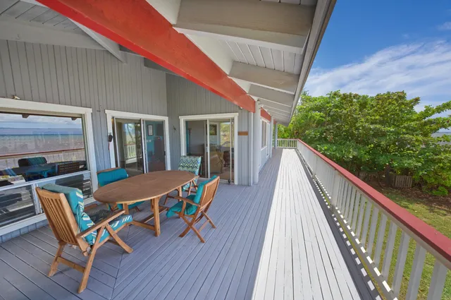 a view of a two chairs in the balcony