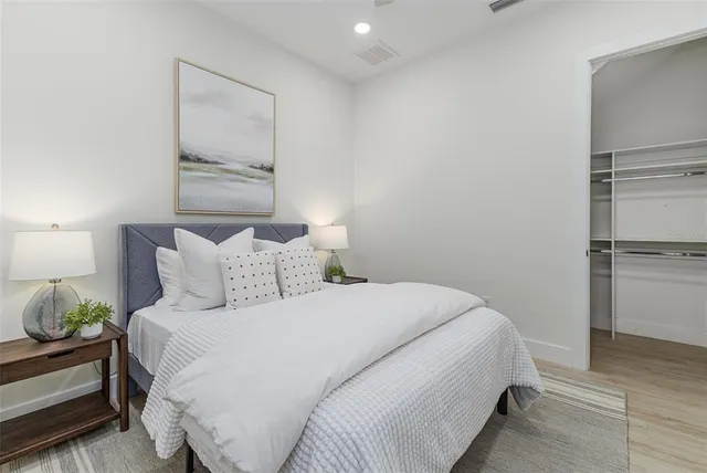 a bedroom with a bed and a night stand