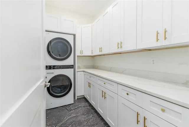 a utility room with sink dryer and washer