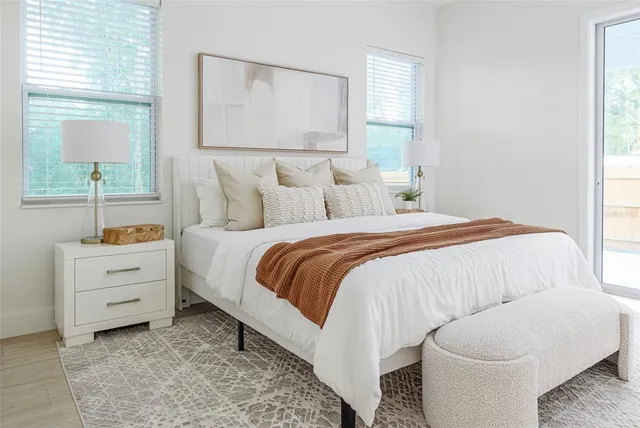 a bedroom with a bed and a window